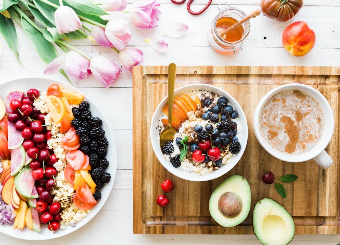 Fruit and a breakfast bowl on a table.