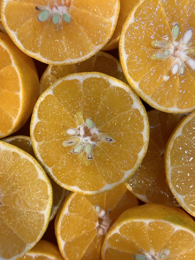Freshly cut satsuma halves with bright orange flesh.